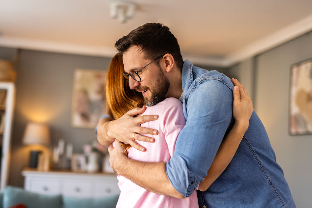 Man embracing woman after opioid rehab session