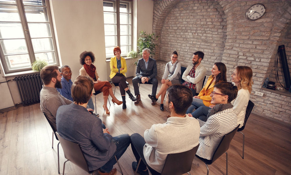 overhead shot of group therapy for addiction and mental health treatment in Masachusetts