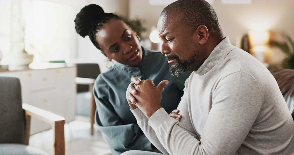 woman reassuring man during therapy for anxiety treatment in Massachusetts